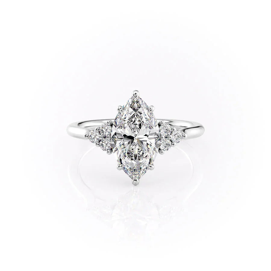The Scarlett. A White Gold Side Stones, Three Stone Engagement Ring Set With A 2ct Marquise Lab Grown Diamond. White Background.