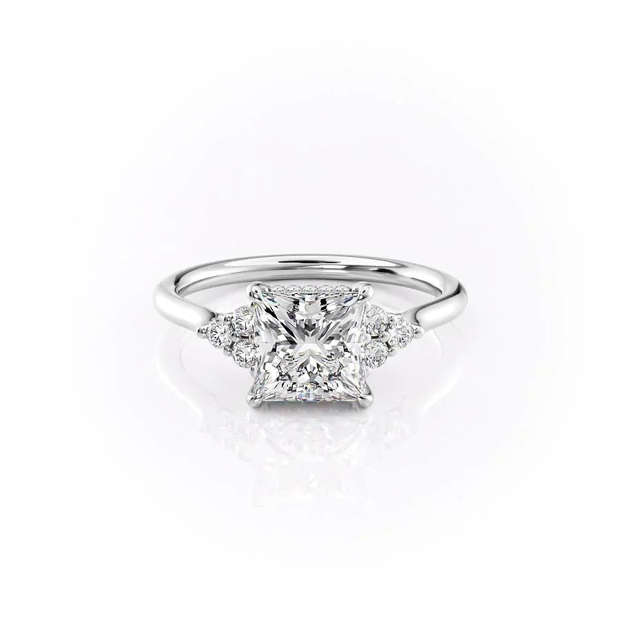 The Scarlett. A White Gold Side Stones, Three Stone Engagement Ring Set With A 2ct Princess Lab Grown Diamond. White Background.