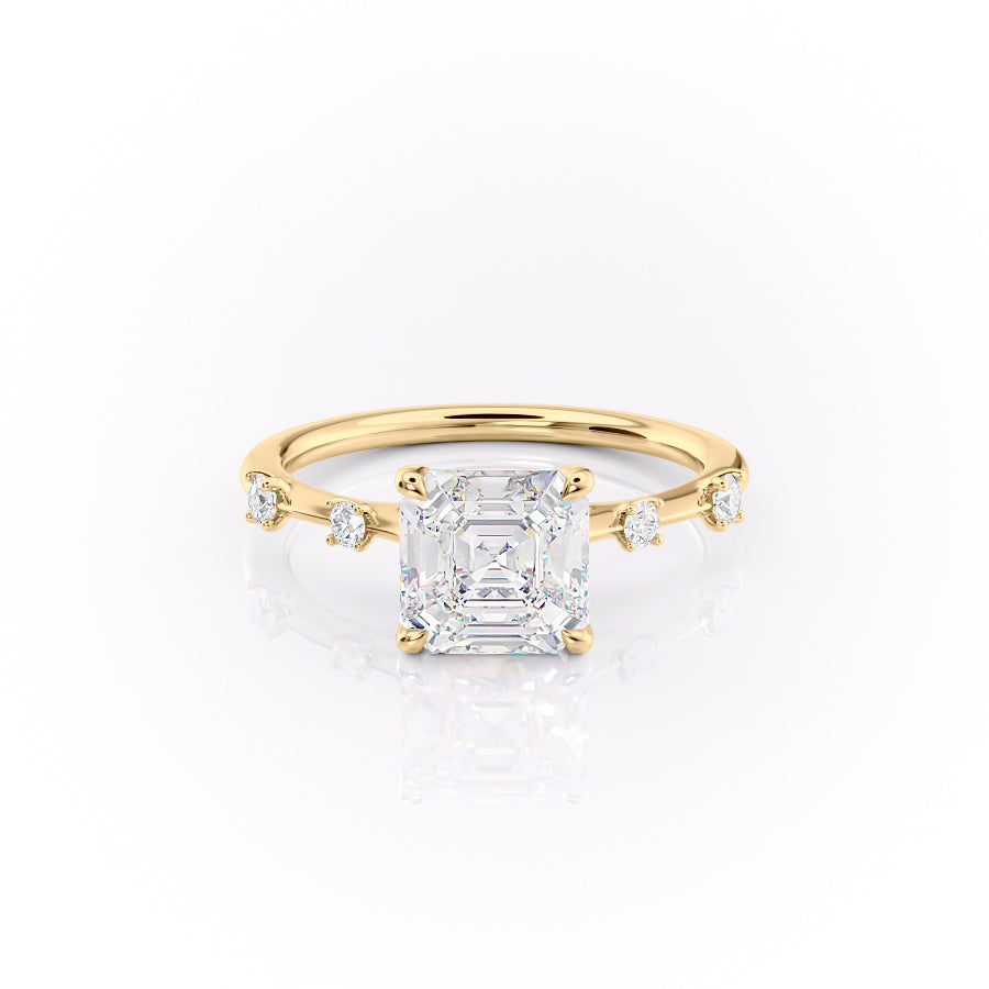 The Serena. A Yellow Gold Side Stones Engagement Ring Set With A 2ct Asscher Lab Grown Diamond. White Background.