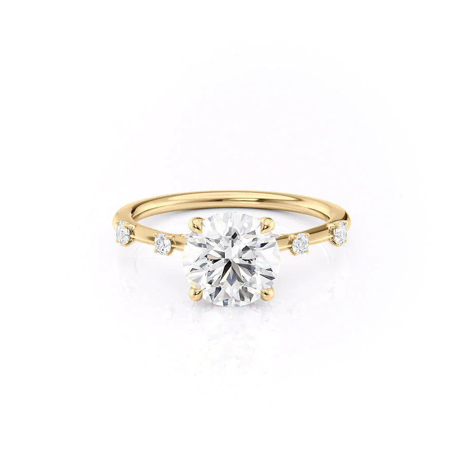 The Serena. A Yellow Gold Side Stones Engagement Ring Set With A 2ct Round Lab Grown Diamond. White Background.