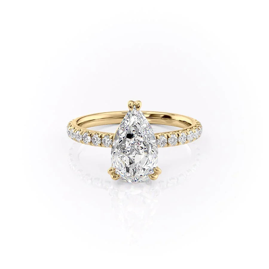 The Sofia. A Yellow Gold Pave, Hidden Halo Engagement Ring Set With A 2ct Pear Lab Grown Diamond. White Background.