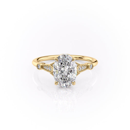 The Stephanie. A Yellow Gold Vintage, Side Stones Engagement Ring Set With A 2ct Oval Lab Grown Diamond. White Background.