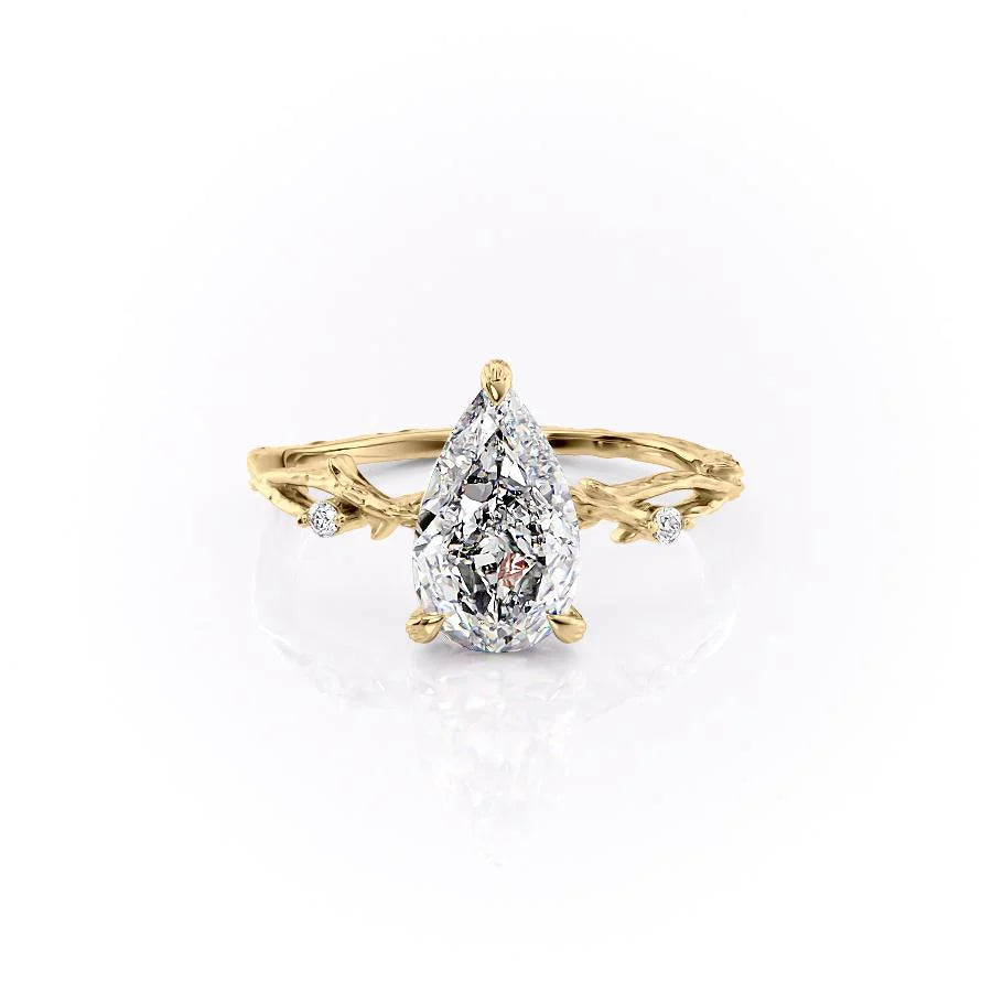 The Textured Twig. A Yellow Gold Solitaire, Nature, Three Stone, Side Stones Engagement Ring Set With A 2ct Pear Lab Grown Diamond. White Background.