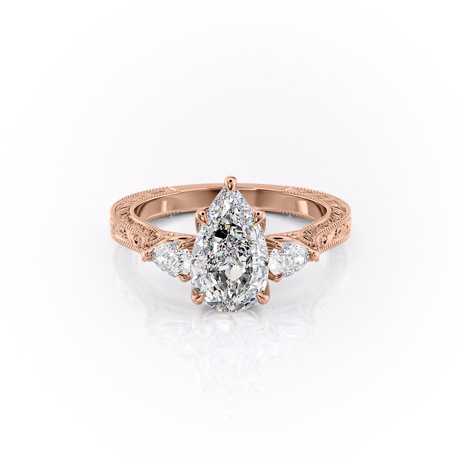 The Three Stone Sierra. A Rose Gold Vintage Engagement Ring Set With A 2ct Pear Lab Grown Diamond. White Background.
