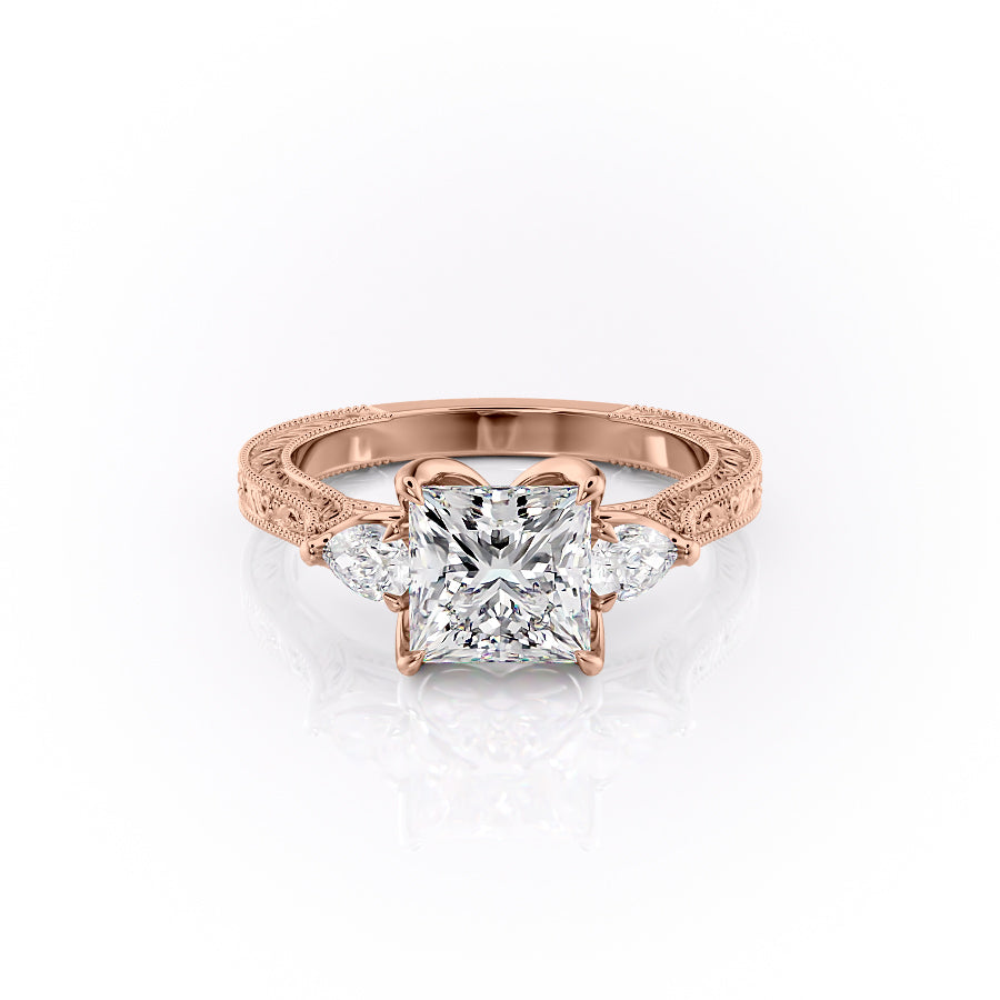 The Three Stone Sierra. A Rose Gold Vintage Engagement Ring Set With A 2ct Princess Lab Grown Diamond. White Background.