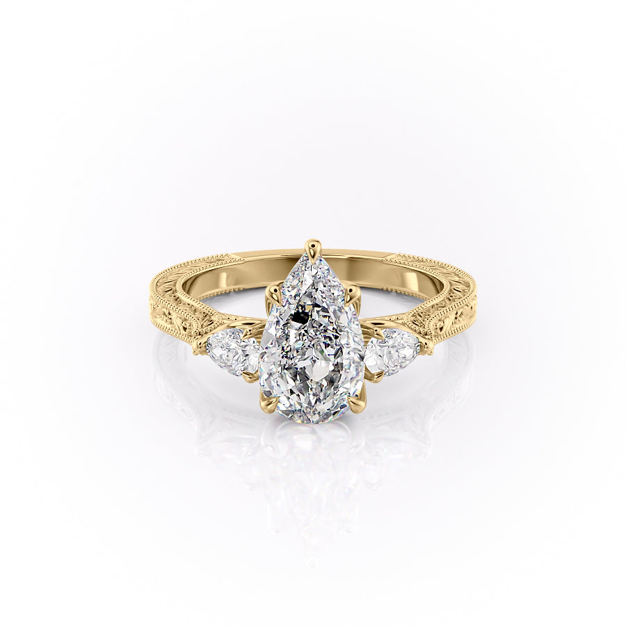 The Three Stone Sierra. A Yellow Gold Vintage Engagement Ring Set With A 2ct Pear Lab Grown Diamond. White Background.