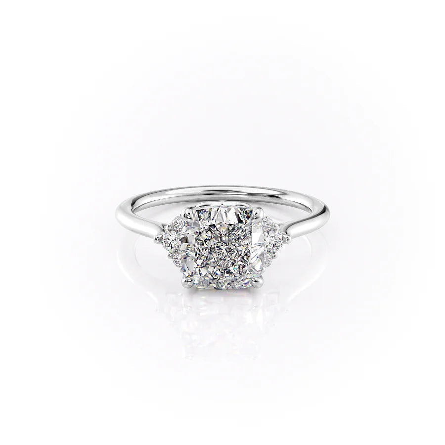 The Victoria. A White Gold Three Stone, Side Stones Engagement Ring Set With A 2ct Cushion Lab Grown Diamond. White Background.