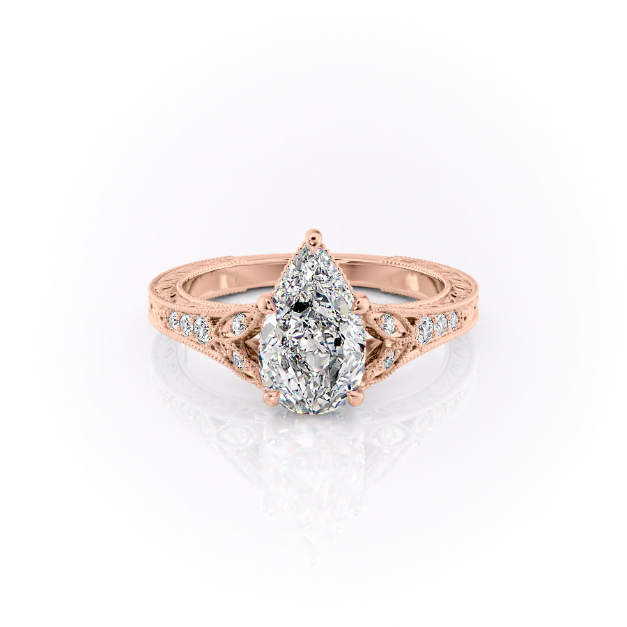 The Violet. A Rose Gold Vintage, Side Stones Engagement Ring Set With A 2ct Pear Lab Grown Diamond. White Background.