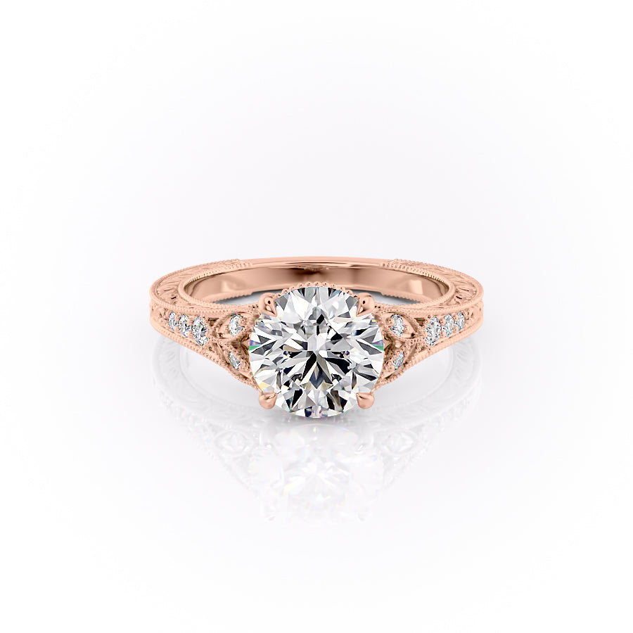 The Violet. A Rose Gold Vintage, Side Stones Engagement Ring Set With A 2ct Round Lab Grown Diamond. White Background.