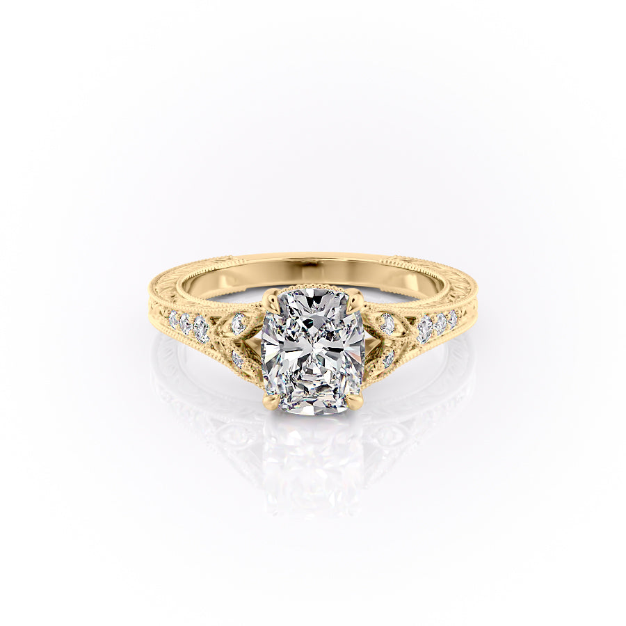 The Violet. A Yellow Gold Vintage, Side Stones Engagement Ring Set With A 2ct Elongated Cushion Lab Grown Diamond. White Background.
