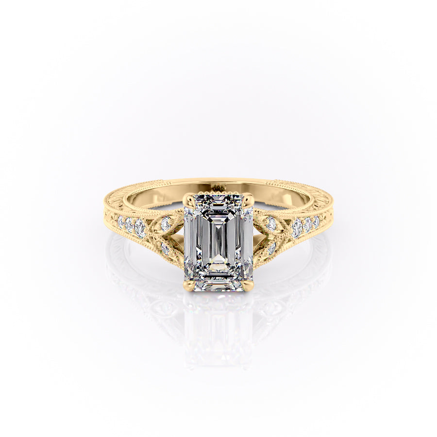 The Violet. A Yellow Gold Vintage, Side Stones Engagement Ring Set With A 2ct Emerald Lab Grown Diamond. White Background.