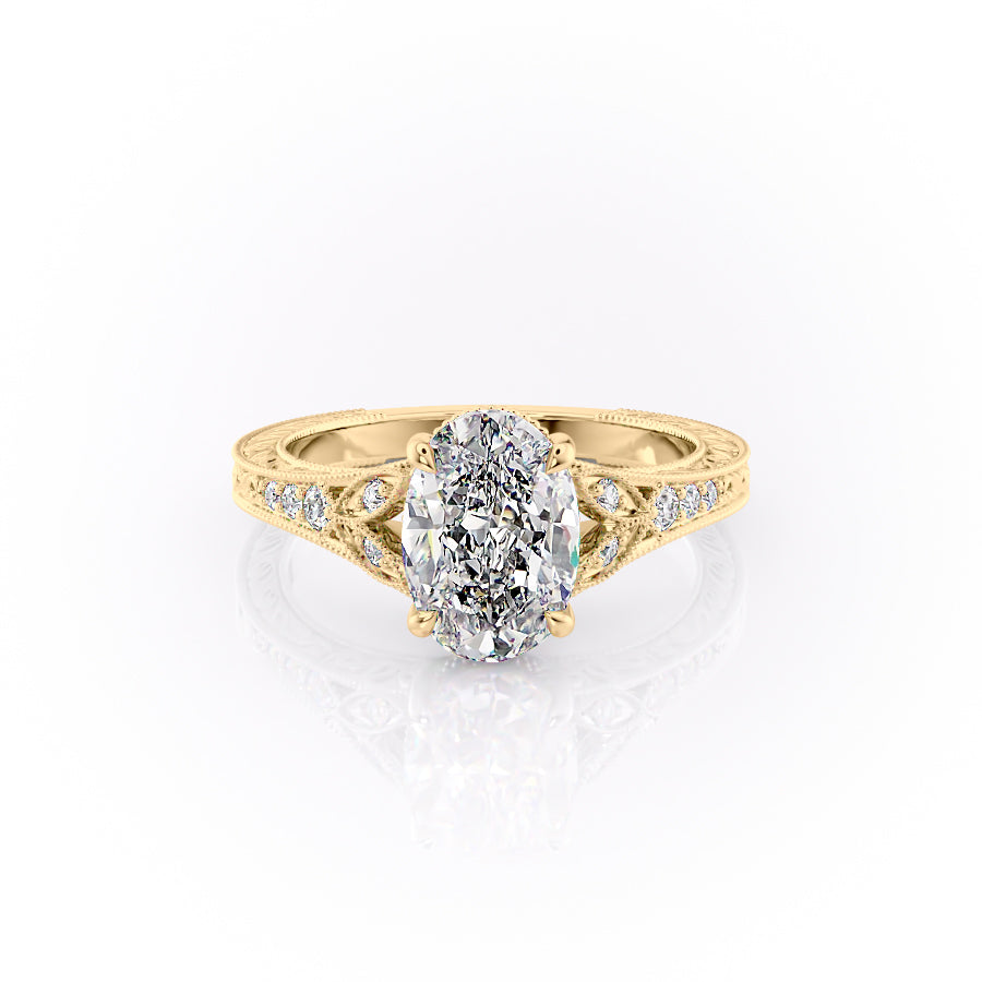 The Violet. A Yellow Gold Vintage, Side Stones Engagement Ring Set With A 2ct Oval Lab Grown Diamond. White Background.